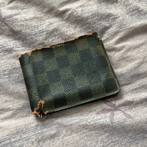 Vintage Louis Vuitton wallet. Wallet is very old cracking and a bit rotted.